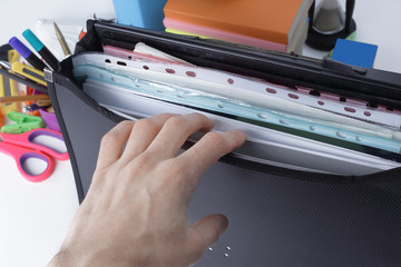 close up. briefcase with file folders and school supplies on white background