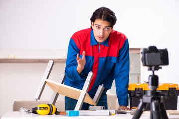 Young contractor recording video for his blog 