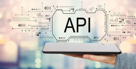 API concept with man holding a tablet computer