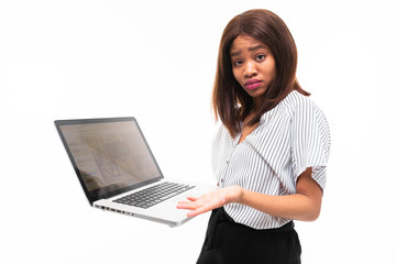 smilling dark-skinned young girl present smth on the laptop isolated on background