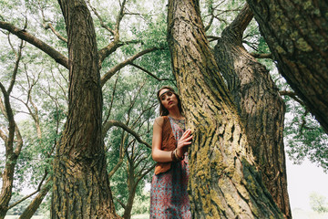young hippie woman on a walk in the woods