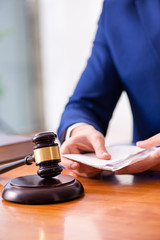 Young male judge sitting in courtroom 