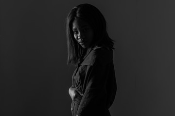 Obraz premium Portrait of a beautiful natural young African woman possing over black background