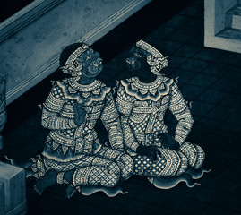 Fototapeta premium Bangkok, Thailand - May 19, 2019: The Ramakian (Ramayana) mural paintings are black and white color isolated wall pattern along the galleries of the Temple of the Emerald Buddha, grand palace 