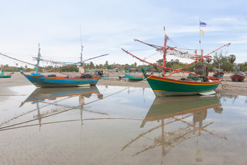 Wooden fishing boat on the  low tide beach