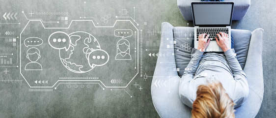 Learning Language concept with man using a laptop in a modern gray chair