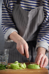 Woman cutting gren apples