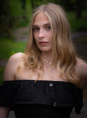 Naklejka premium Portrait of pretty blond woman wearing black