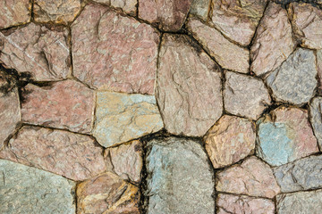 Close up grunge stone wall of the large colored cement