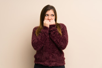 Young girl nervous and scared putting hands to mouth