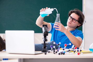Young male student in the classroom 
