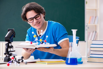Young male student in the classroom 