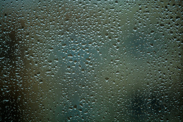 Background or texture. It is a lot of small a rain drops on window glass. Rainy day of spring.
