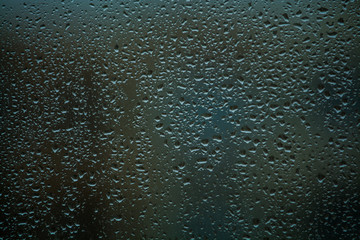 Background or texture. It is a lot of small a rain drops on window glass. Rainy day of spring.