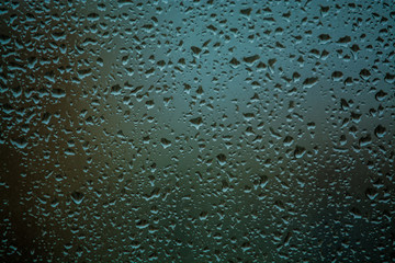 Background or texture. It is a lot of small a rain drops on window glass. Rainy day of spring.