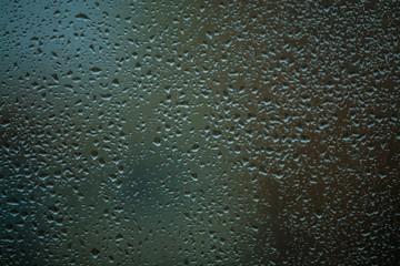 Background or texture. It is a lot of small a rain drops on window glass. Rainy day of spring.