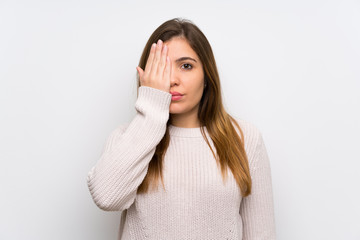 Young girl with white sweater covering a eye by hand