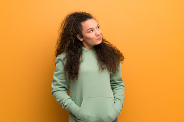 Teenager girl over ocher wall.