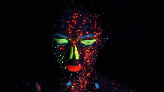 portrait of a girl in the neon light. face of a beautiful girl is painted with glowing colors