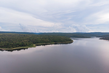 Drone shot Aerial view landscape scenic of big river reservoir with nature forest and mountains in tropical land