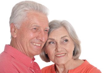 Close-up portrait of smiling senior couple wearing bright clothing