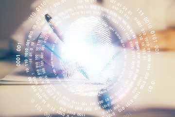 Blue fingerprint hologram over woman's hands taking notes background. Concept of protection. Double exposure