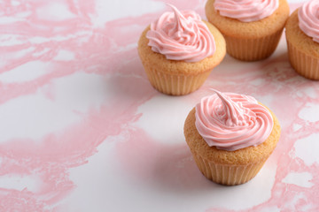 closeup vanilla cupcake with pink frosting