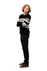 Fototapeta premium Full-length shot of Blonde man with arms crossed and happy over isolated white background