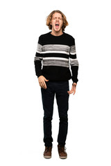 Full-length shot of Blonde man shouting to the front with mouth wide open over isolated white background