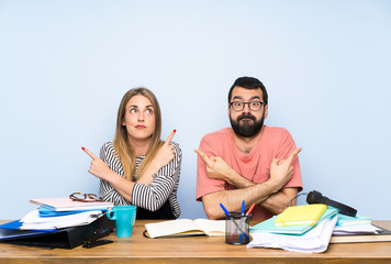 Students with many books pointing to the laterals having doubts