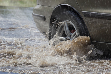 motion car rain big puddle of water spray from the wheels