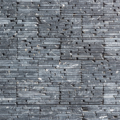 River pebble wall tile background natural texture cross-section cut structure design in dark black grey