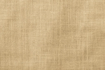 Hessian sackcloth woven texture pattern background in light yellow gold cream color