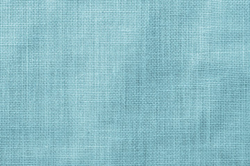 Hessian sackcloth woven texture pattern background in light cyan green blue