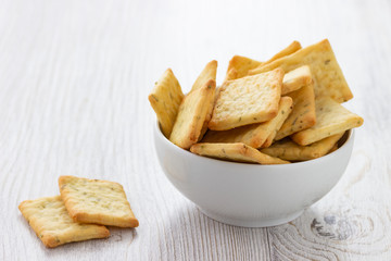 Dry salty cracker cookies in bowl on the table