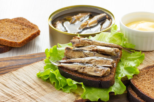 Tasty fish sandwich with bread and canned sprats