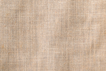 Hessian sackcloth woven texture pattern background in tan sepia beige cream brown color