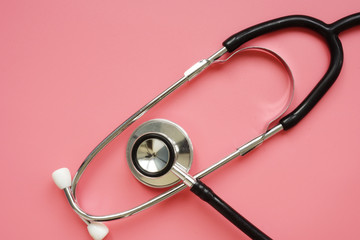 Women Health concept. Stethoscope on a pink background.