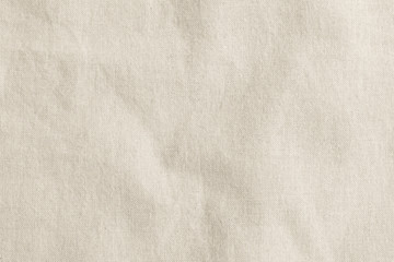 Muslin fabric cloth woven texture pattern background in light cream brown color