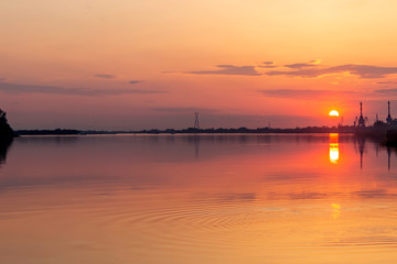 Fototapeta na wymiar Beautiful orange sunset on the river.