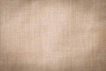 Hessian sackcloth woven texture pattern background in light cream beige brown color