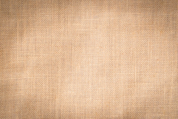 Hessian sackcloth woven texture pattern background in light cream beige brown color