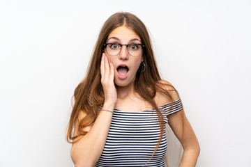 Young woman with long hair over isolated white wall with glasses and surprised
