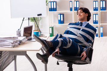 Young tied male employee in the office 
