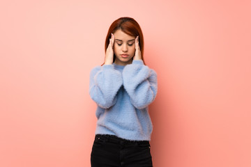 Young redhead woman over pink background unhappy and frustrated with something