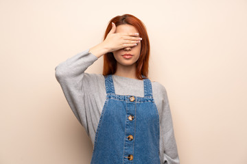 Young redhead woman over isolated background covering eyes by hands. Do not want to see something