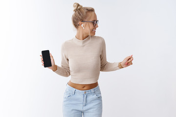 Technology, lifestyle and music concept. Portrait of good-looking carefree stylish blond woman in...
