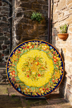 Detail of public walls in Deruta, a town in Umbria famous for its artistic ceramics manufactured and hand-painted, Italy. Vases, amphorae, plates, objects of furniture in ancient majolica.
