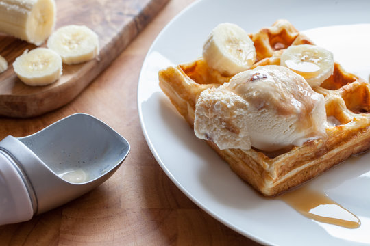 Banana waffle close-up. Delicious breakfast dessert meal prepared on plate
