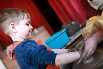 Happy kid at potters wheel